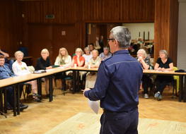 policjant rozmawia z seniorami w UM Zakopane 2